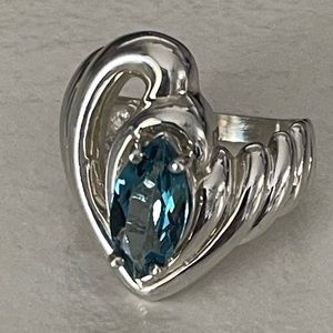 Custom made piece. Marquis London blue topaz set in a silver swirl ring.